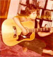 Doug playing the guitar at 9 yrs.old
